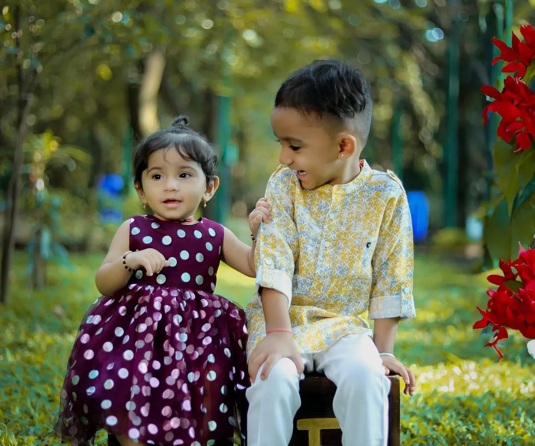 The sweet bond between siblings captured during a relaxed outdoor photoshoot in a Bangalore park. We love creating a fun atmosphere where kids can be themselves, resulting in genuine smiles and candid family portraits.
