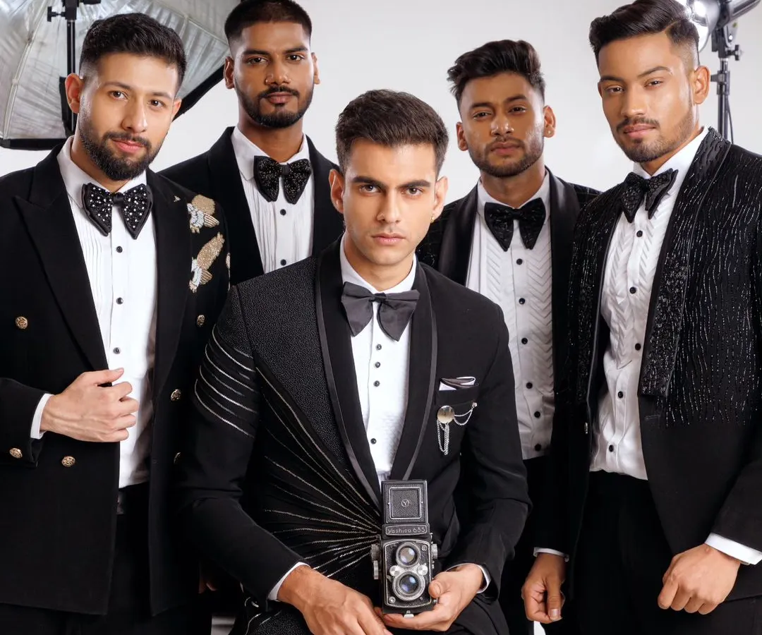 A group of groomsmen showcasing our range of designer tuxedos. Each suit features unique details, from varied lapel styles to distinct embellishments, creating a coordinated but not uniform look for a modern wedding party.