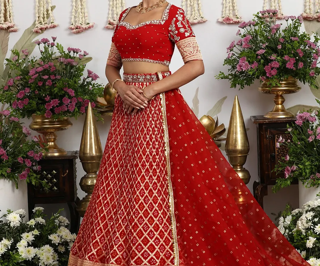 A timeless heirloom, this classic red silk lehenga is a tribute to bridal tradition. The rich golden embroidery and regal Banarasi weave are crafted for a bride's most cherished day, promising a look of unparalleled grace and splendor.