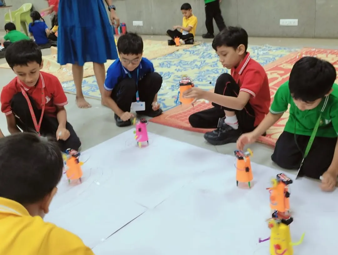 It's robot race day! After building their own scribbling bots from scratch, students get to see their creations come to life, drawing unique patterns as they zoom around.