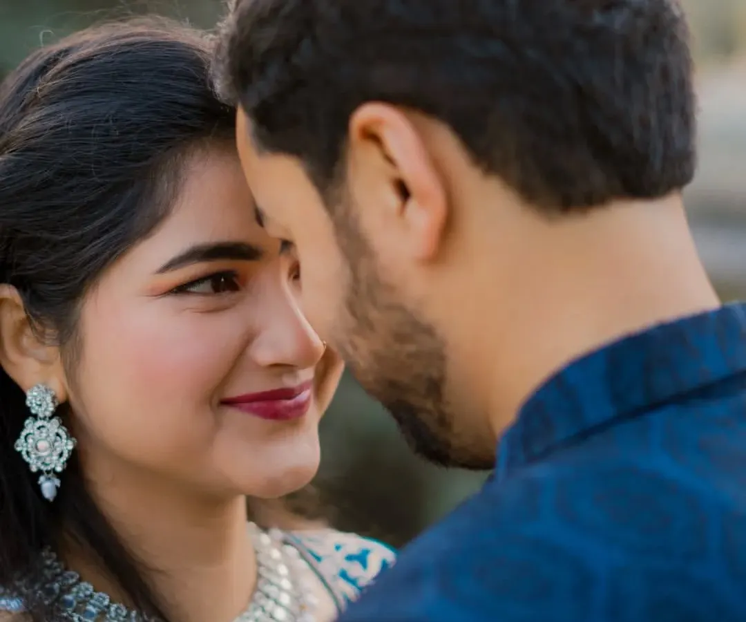Beyond the grand locations, we focus on the quiet moments of connection. This intimate close-up captures a gentle, loving glance, showcasing our ability to direct and capture genuine emotion between a couple.