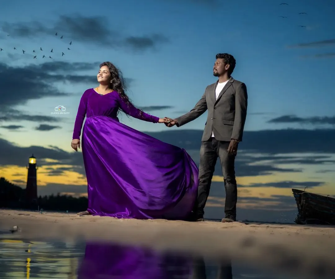 I love how this purple velvet and satin gown looks against the sunset. It's a perfect choice for a romantic pre-wedding shoot, offering a rich color and a fabric that catches the light beautifully.