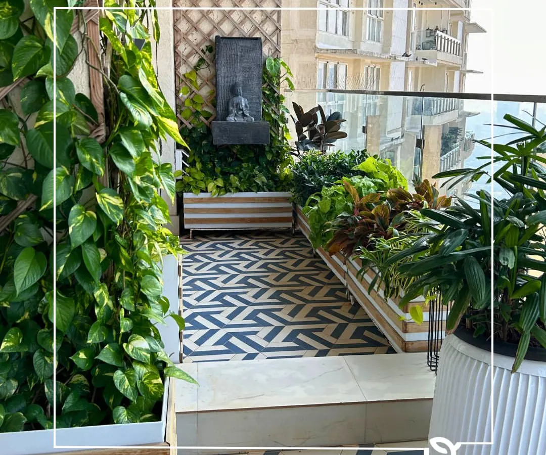 Even a compact city balcony can become a lush, private oasis. We transformed this space with a vertical green wall, custom planters, and a mix of foliage and flowering plants, creating a perfect corner for relaxation with a stunning view.