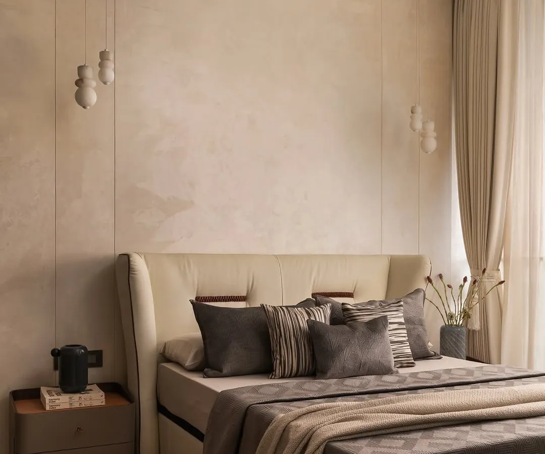 I believe a neutral palette is the perfect canvas for tranquility. In this master bedroom, I layered various shades of beige and grey with different textures, from the plush headboard to the soft linens, creating a space that feels both sophisticated and incredibly restful.