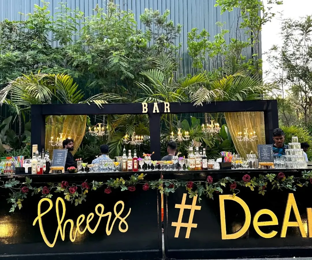 This is our classic black and gold wedding bar setup, perfect for an elegant cocktail party. We customize the bar front with details like the event hashtag, making it a central feature of your celebration.