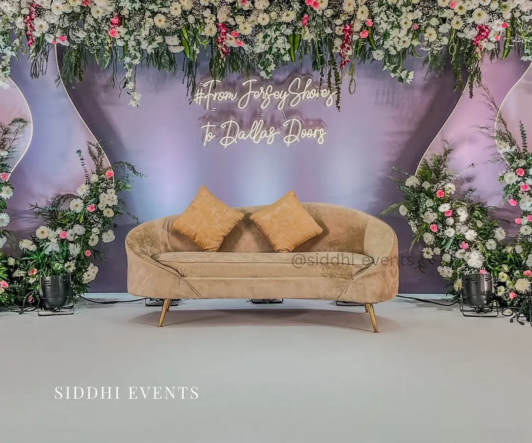 We brought this couple's long-distance love story to life with a personalized neon sign and a modern, elegant stage design, blending soft lavender with lush florals for their engagement.