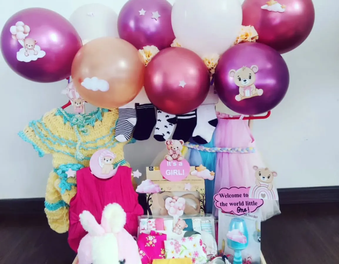 Hello, Princess! This hamper is all about celebrating a baby girl with soft pinks and purples. I've included cozy knitwear, a plush bunny, and festive balloons to create a beautiful and practical gift for a baby shower or to welcome the newborn.