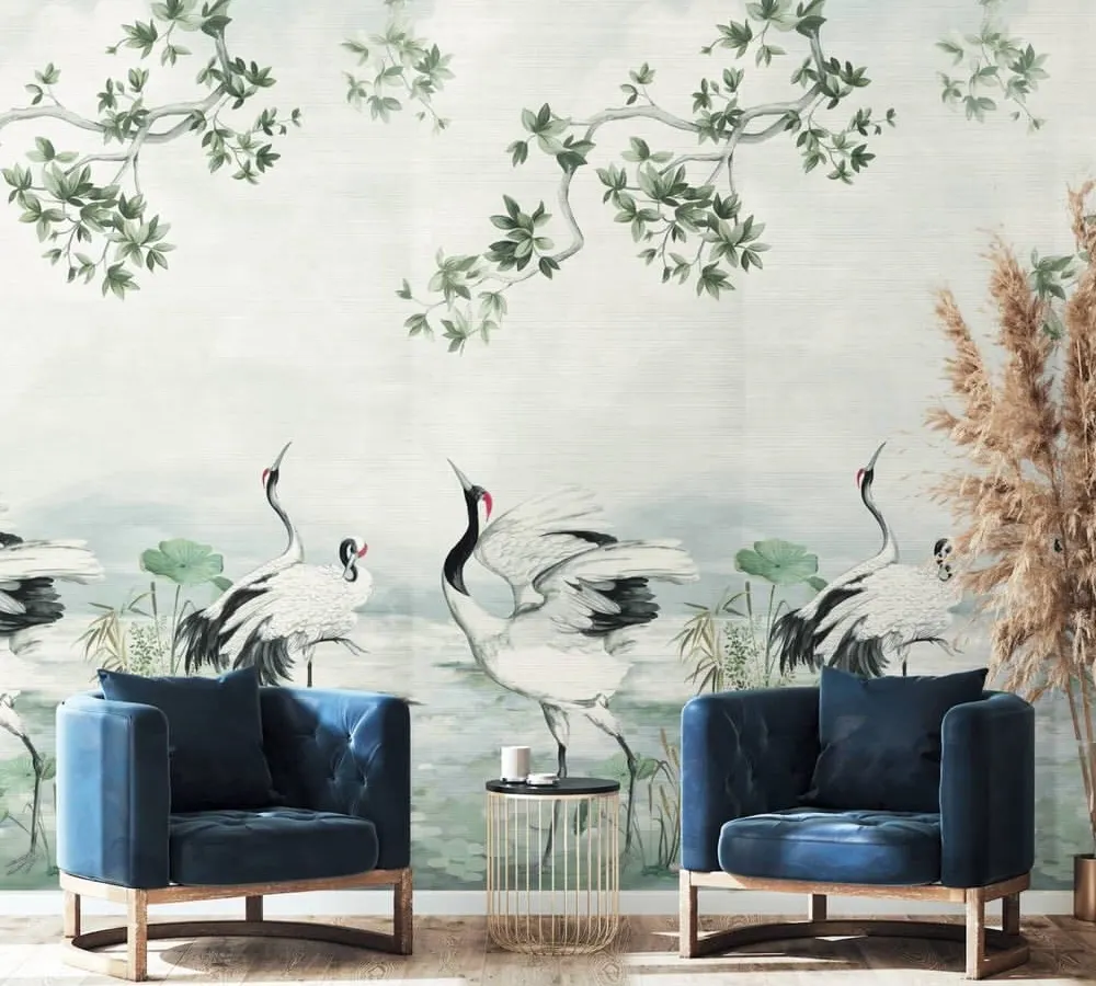 This scenic wallcovering from the Daisy Bennett collection transforms a sitting area into a work of art. The hand-painted style, featuring elegant cranes amidst serene foliage, offers a bespoke, poetic quality that elevates the entire space.
