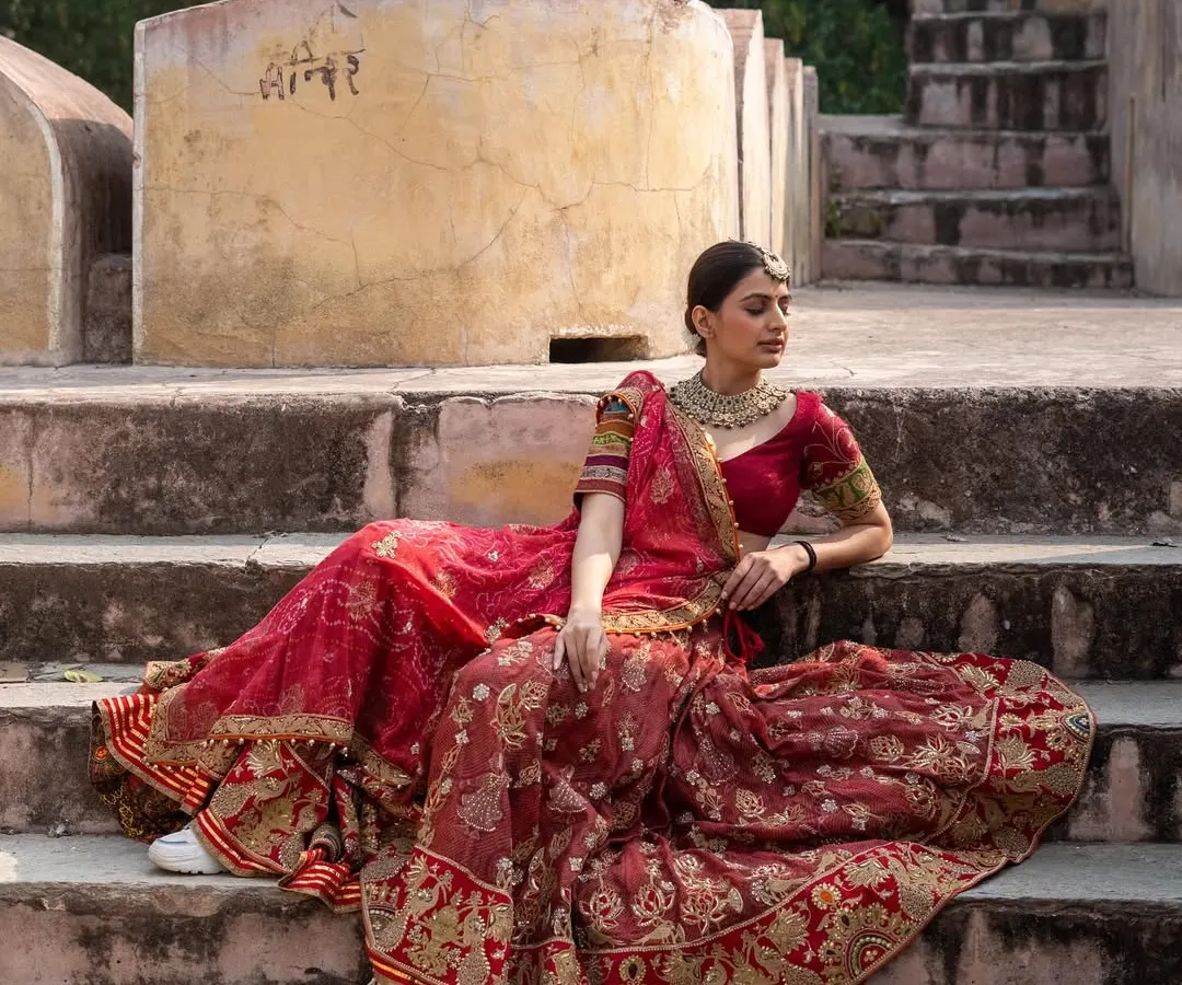 For the bride who wants a truly royal look. This is an incredibly intricate designer bridal lehenga in a classic red, perfect for making a grand entrance on your wedding day.