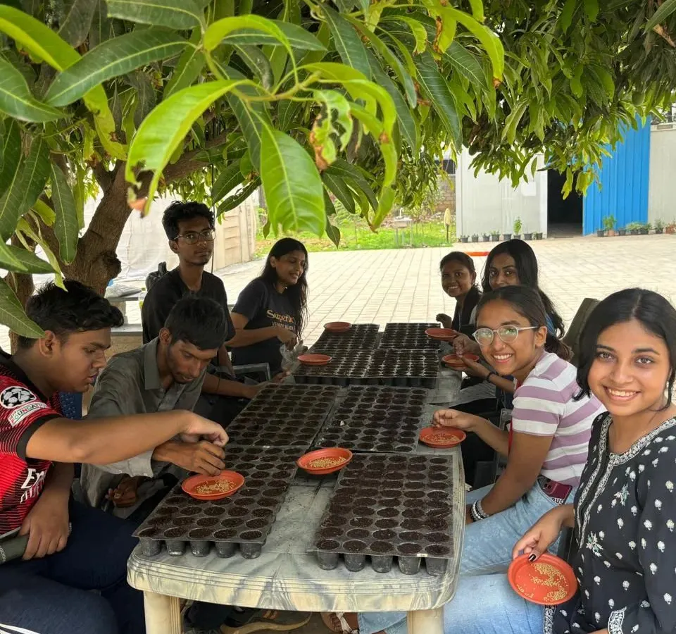 Our workshops are all about getting your hands dirty. Here, we are guiding students through the process of sowing seeds, the very first step in their journey to becoming urban farmers.
