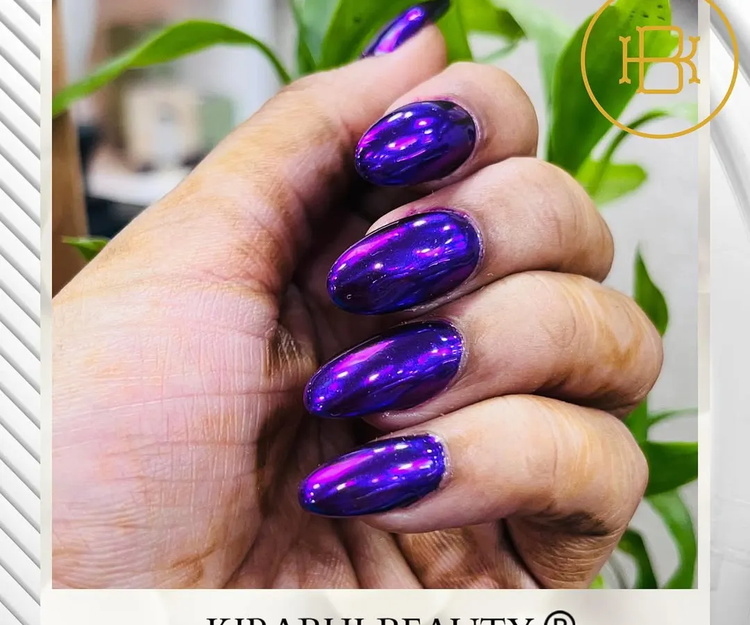 For those who love to make a statement, this metallic purple chrome finish is a showstopper. I apply a special chrome powder over a gel base to get this incredible liquid-metal effect on these almond-shaped extensions.