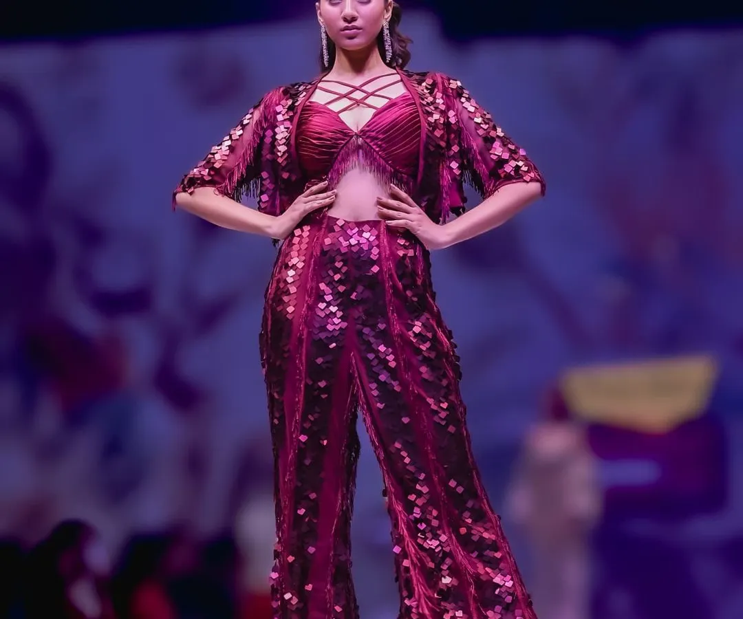 The runway is a place of high energy and bold statements. My goal here was to capture the power and drama of this sequined magenta outfit, using the stage lighting to highlight its texture and the model's confident pose.