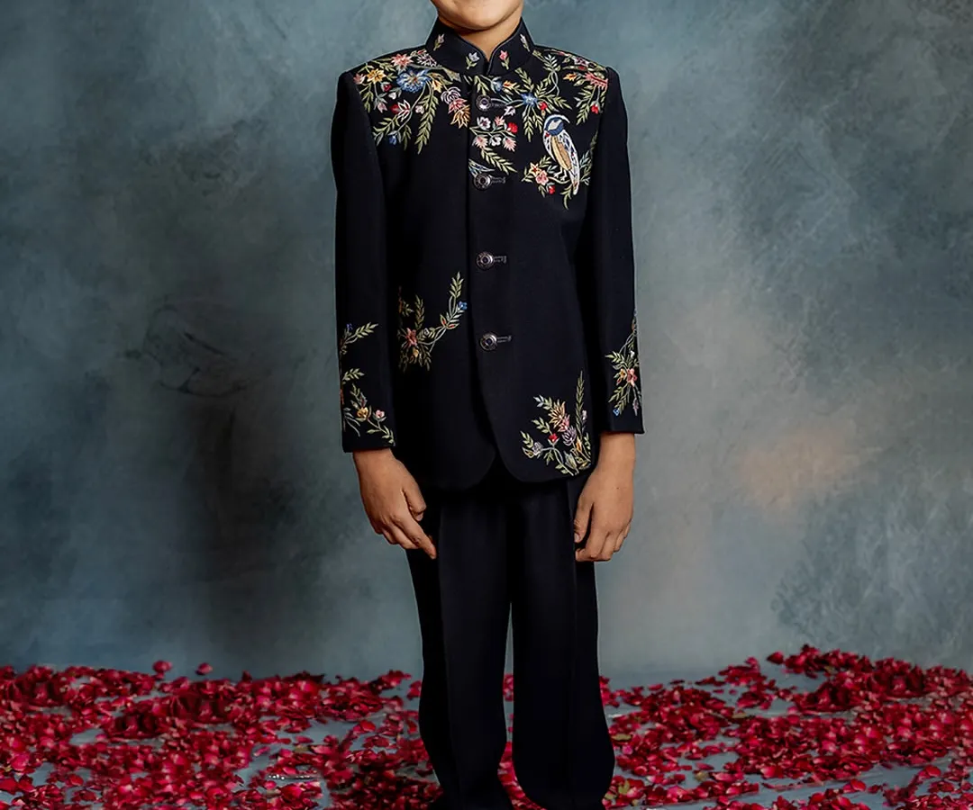 This is where modern style meets timeless craftsmanship. Our bestselling Indo-western jacket features intricate floral and bird embroidery on a classic black base, perfect for any celebration where your boy deserves to be the star.