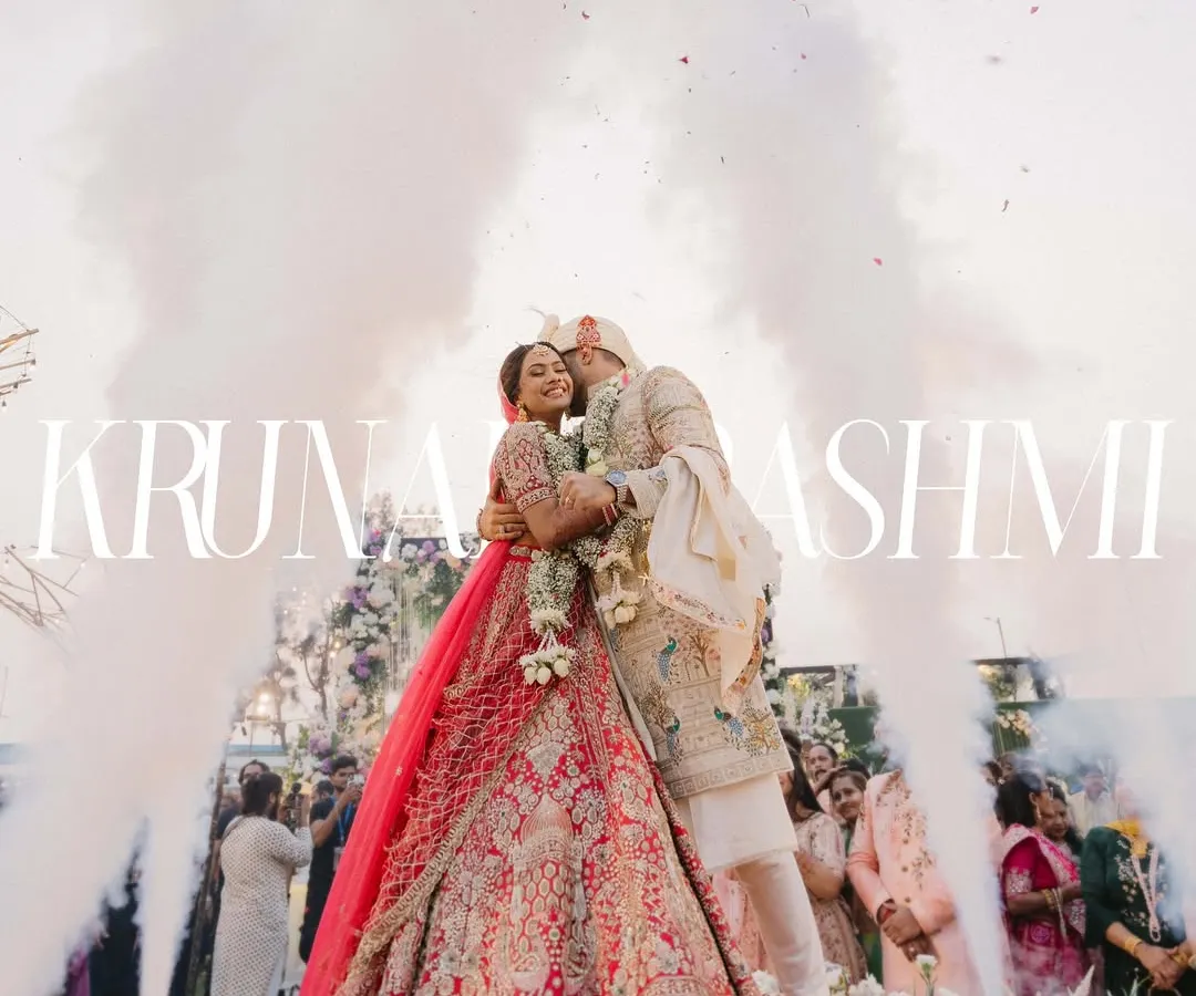 A moment of pure cinematic magic for Krunal and Rashmi. As they embraced, surrounded by a cloud of celebratory smoke and flowers, it felt like the world stood still just for them. This is the kind of grand, unforgettable memory I strive to create.