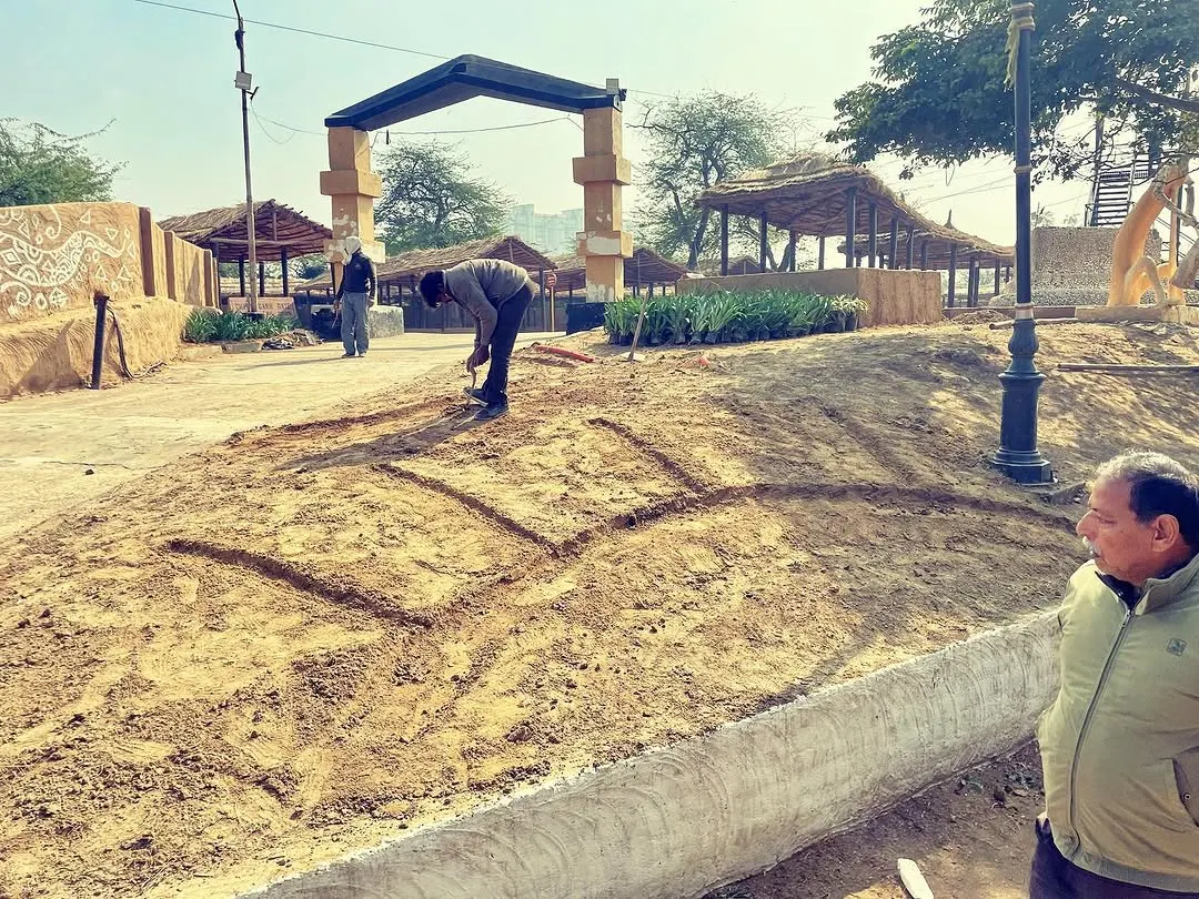 Every big project starts with a simple line in the dirt. This is me marking out the landscape design for a large flower bed at the Surajkund Mela. This initial groundwork is crucial for bringing the final vision to life.