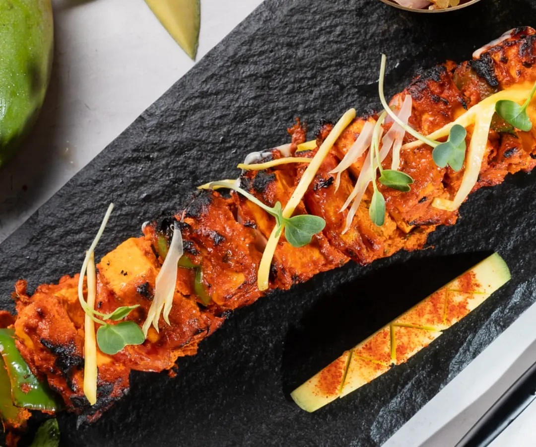 I believe food should be both delicious and visually stunning. This Mango Paneer Tikka, artfully plated on a slate board, is a perfect example of how I elevate classic dishes with a modern, creative twist, making it an ideal starter for an executive lunch or a special company milestone.