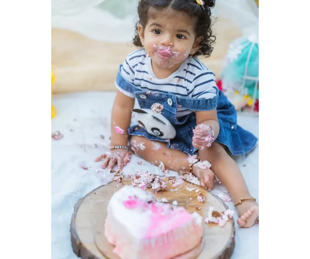 A first birthday isn't complete without a little bit of mess. This cake smash session was all about fun, as little Nitya enjoyed her very own birthday cake. These are the playful, personality-filled moments families cherish.