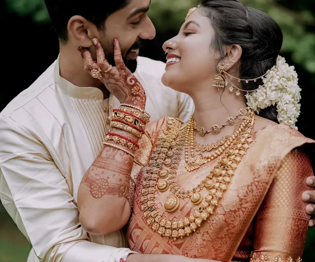 An intimate portrait of a couple, showcasing the deep connection and the intricate beauty of South Indian wedding attire and henna. I focus on capturing these quiet, heartfelt exchanges.