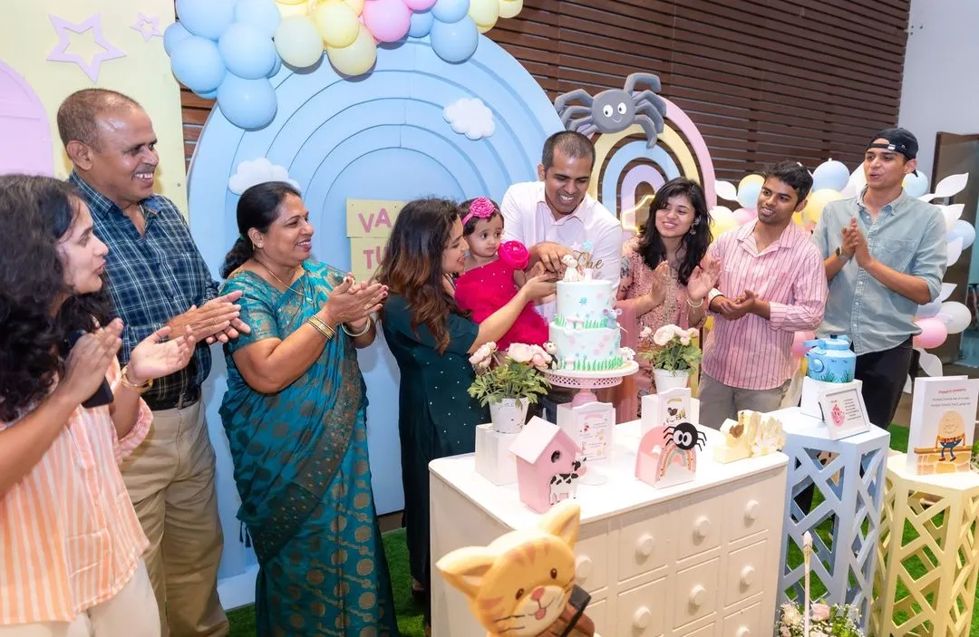 The whole family gathers around for the cake cutting ceremony at a first birthday party. Capturing these multi-generational moments of celebration is what makes small event photography so special for us.