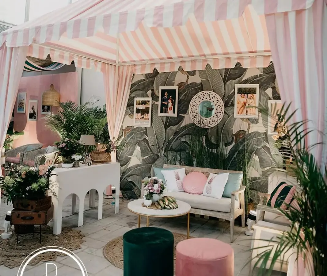 I love bringing a unique theme to life, like this "Hotel California" retro brunch. We recreated the iconic Beverly Hills Hotel cabana, using Martinique wallpaper, custom striped awnings, and personal photos to tell the couple's story with a cool, coastal vibe.