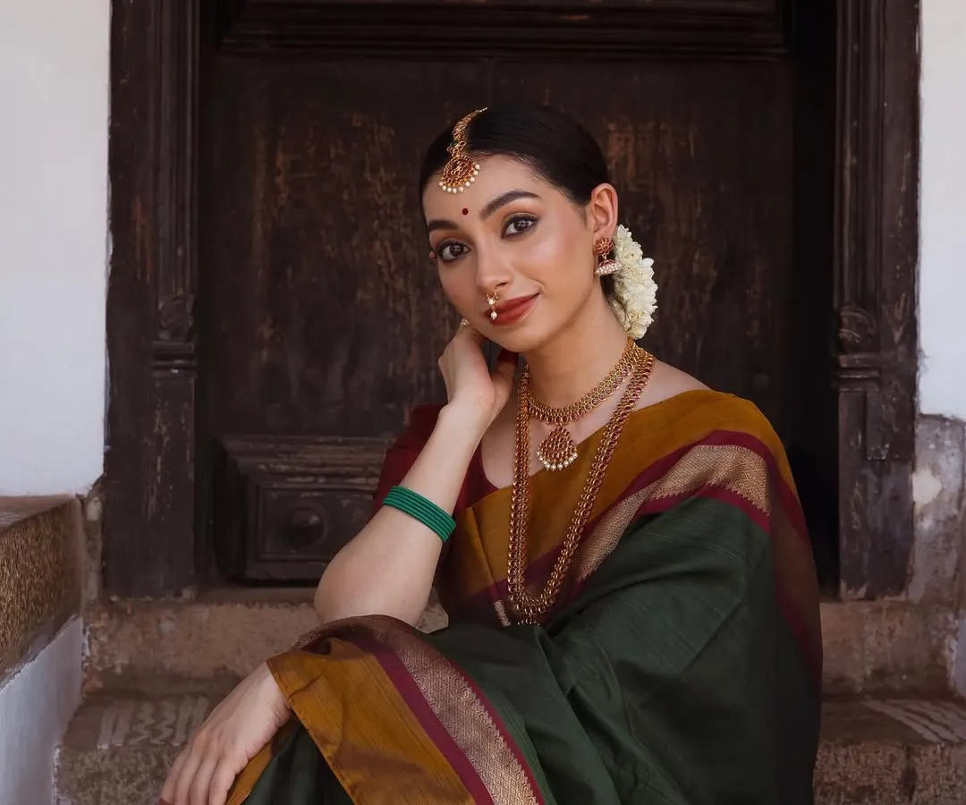 I have a deep passion for heritage jewelry, and this shoot allowed me to embody a classic South Indian aesthetic. The focus here was on showcasing the intricate details of the temple jewelry and the rich texture of the silk saree, creating a timeless bridal or festive look.