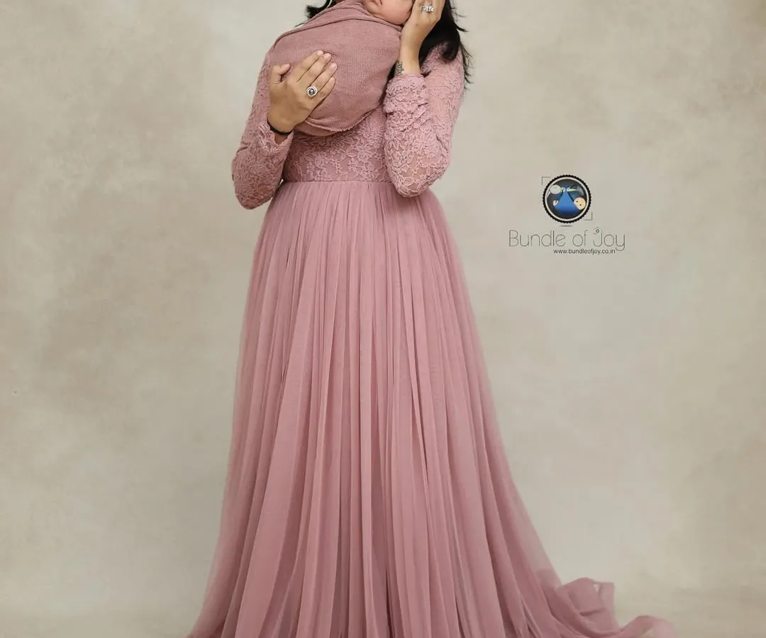 A mother's first embrace is a memory to cherish forever. I provide a selection of beautiful gowns, like this flowing pink one, for moms to wear during their newborn family portraits, creating timeless and elegant images.