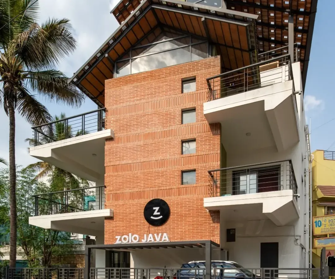 This is the completed exterior of the Earthen Spirit project, a warehouse we repurposed into a modern co-living space called Zolo Java. We added new balconies and a striking multi-layered roof structure, blending the building's industrial past with a fresh, residential feel. The final design stands as a testament to how adaptive reuse can revitalize urban structures.