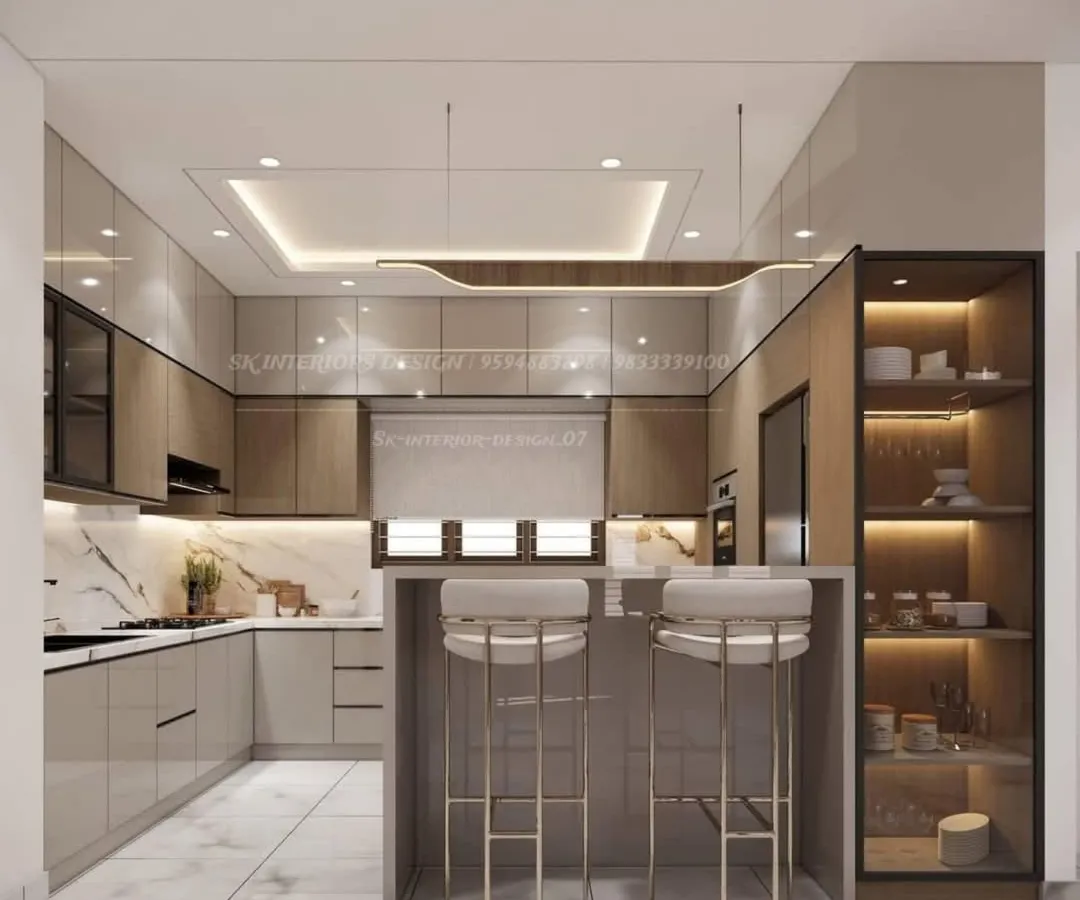 Here is a perfect example of a modern, open-concept kitchen. We designed this U-shaped layout with a breakfast counter, combining glossy beige and wood-finish cabinets with a sleek black countertop and integrated appliances for a seamless look.
