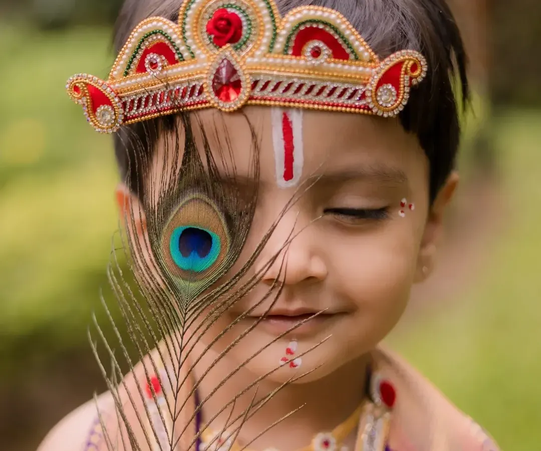 This artistic portrait from a Little Krishna themed shoot is one of my favorites. The way the peacock feather gently covers his eye creates a sense of innocence and divinity, making it a truly special memory for his family.