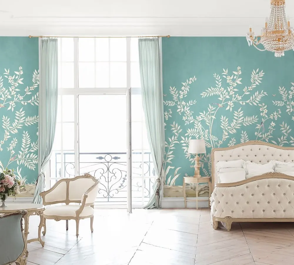 A bedroom should be a sanctuary of serene elegance. In this space, we used a delicate botanical wallpaper to create a whisper of poetry, complemented by classic furniture and light, airy textiles for a timeless and restful atmosphere.