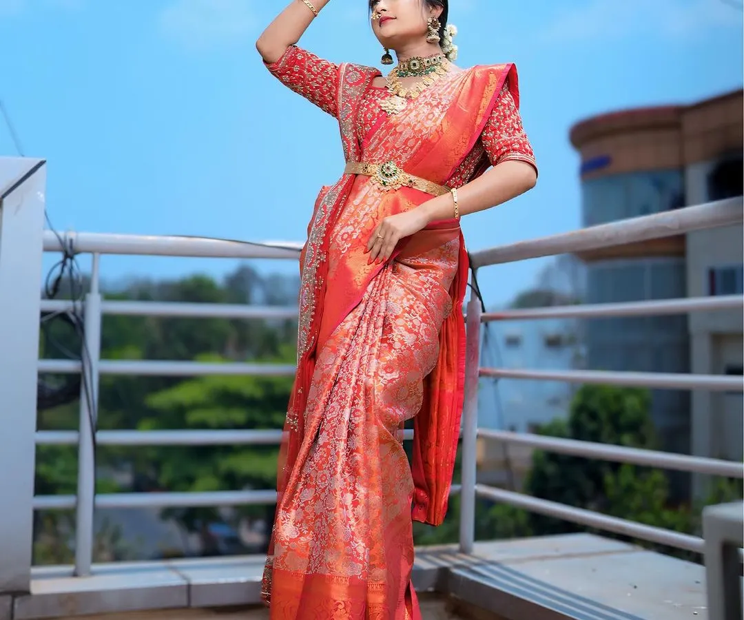 This is the classic South Indian muhurtham bridal look I love to create. I focus on draping heavy silk sarees to create a majestic yet comfortable feel, ensuring the pleats are perfect and the traditional oddiyanam belt sits beautifully.