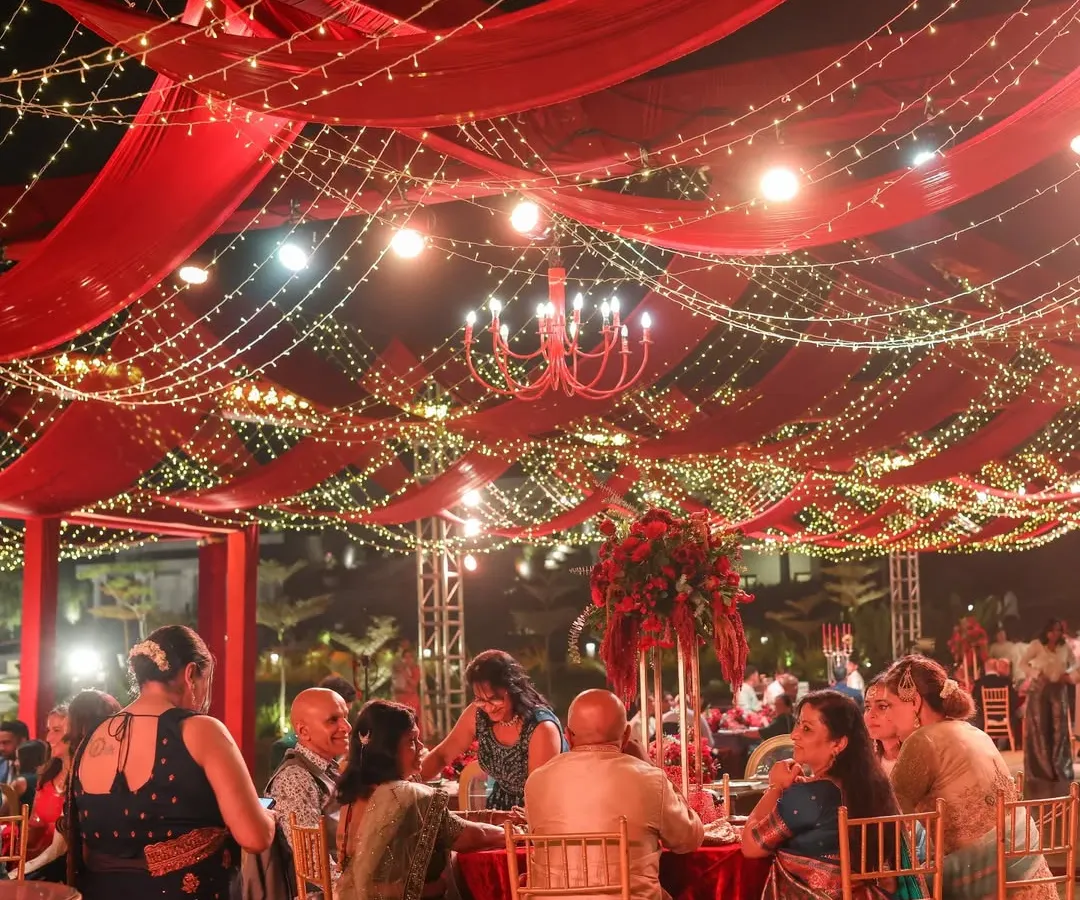We believe a reception should feel like a galaxy of joy. For this night, we draped the sky in rich red fabric and a constellation of fairy lights, creating a warm, vibrant space where guests could share laughter and make memories under the stars.
