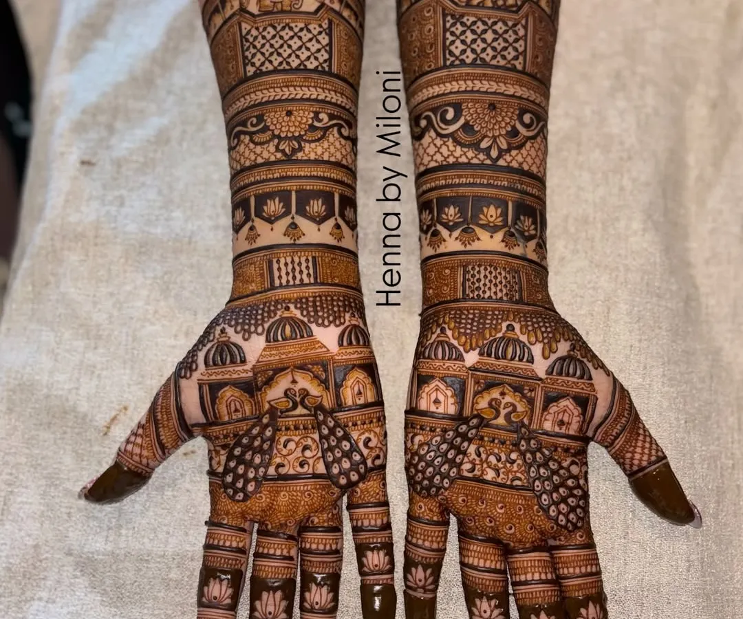 A full bridal mehendi design for both hands, celebrating the spirit of Mumbai. This piece features iconic architectural elements and traditional motifs, creating a symmetrical and grand statement.