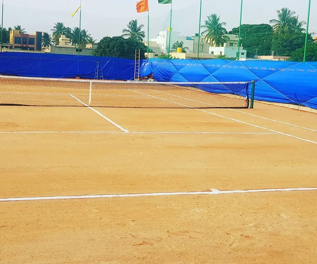 Here is a clear view of our tournament-ready clay court on a bright day. We keep the lines sharp and the surface perfectly prepared, so you get a consistent and professional playing experience every single time.