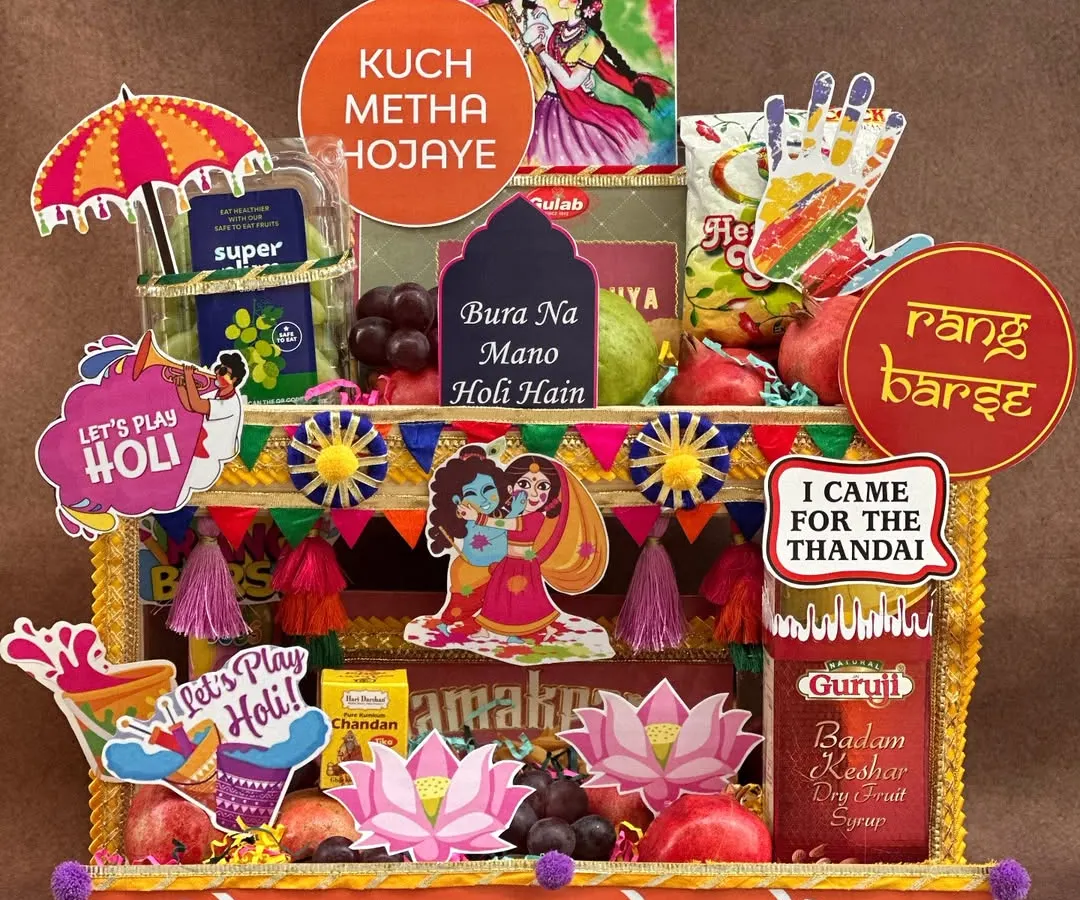Bringing a *rangeen* blast to your Holi celebrations! This hamper is designed to look like a vibrant street stall, packed with fresh fruits, thandai, gujia, and fun props like water guns and colors to get the party started.