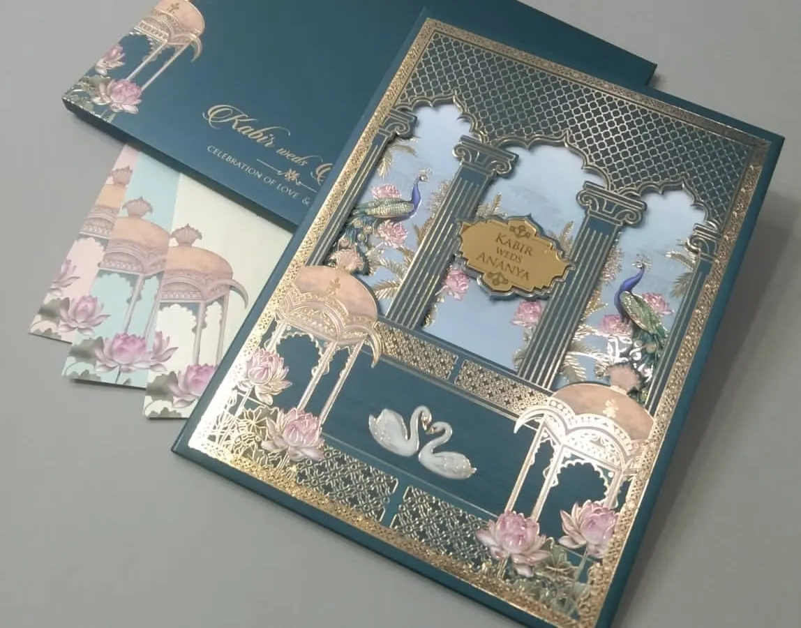 I designed this card with a stunning laser-cut palace gate in rich gold foil against a teal background. The scene is complete with elegant swans and peacocks, creating a fairytale entrance to your wedding details.