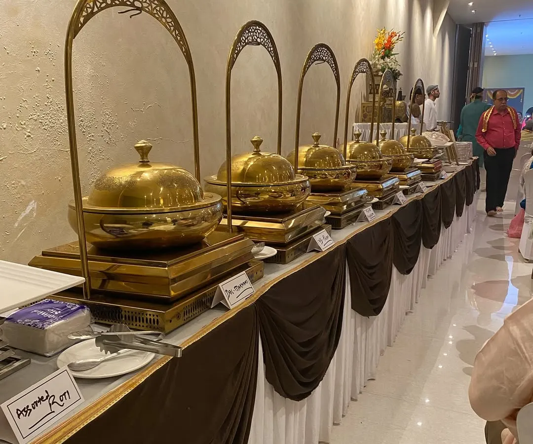We take pride in our buffet presentation, ensuring a grand and inviting feast for your guests. This setup for a Mata ki Chowki event features a full spread of our specialties, all served in beautiful brass chafing dishes.