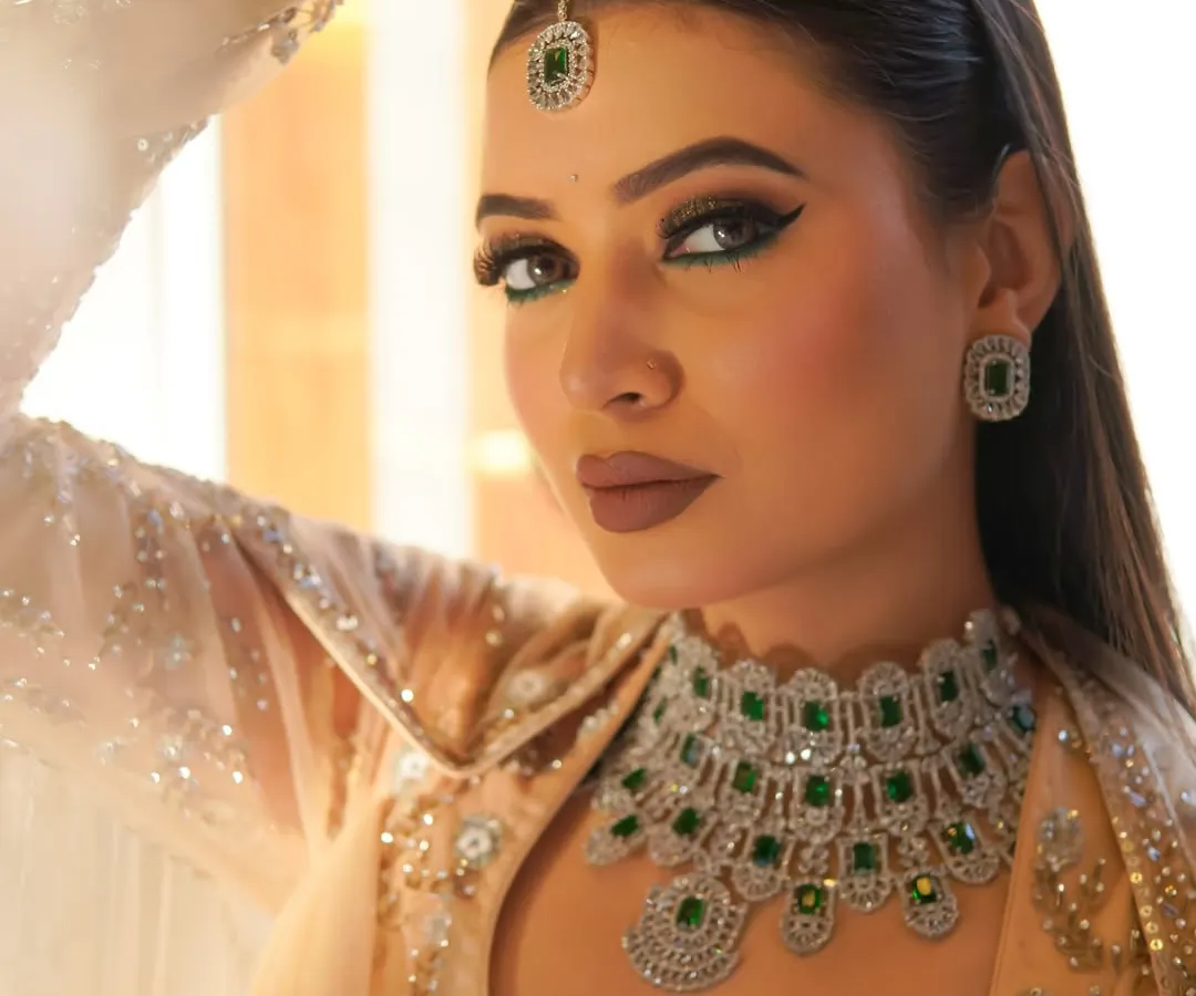 A bold and dramatic look from my Riwayat collection. I created this sharp, emerald green winged eyeliner and paired it with a matte nude lip to complement the stunning traditional jewelry, perfect for a sangeet or wedding guest.