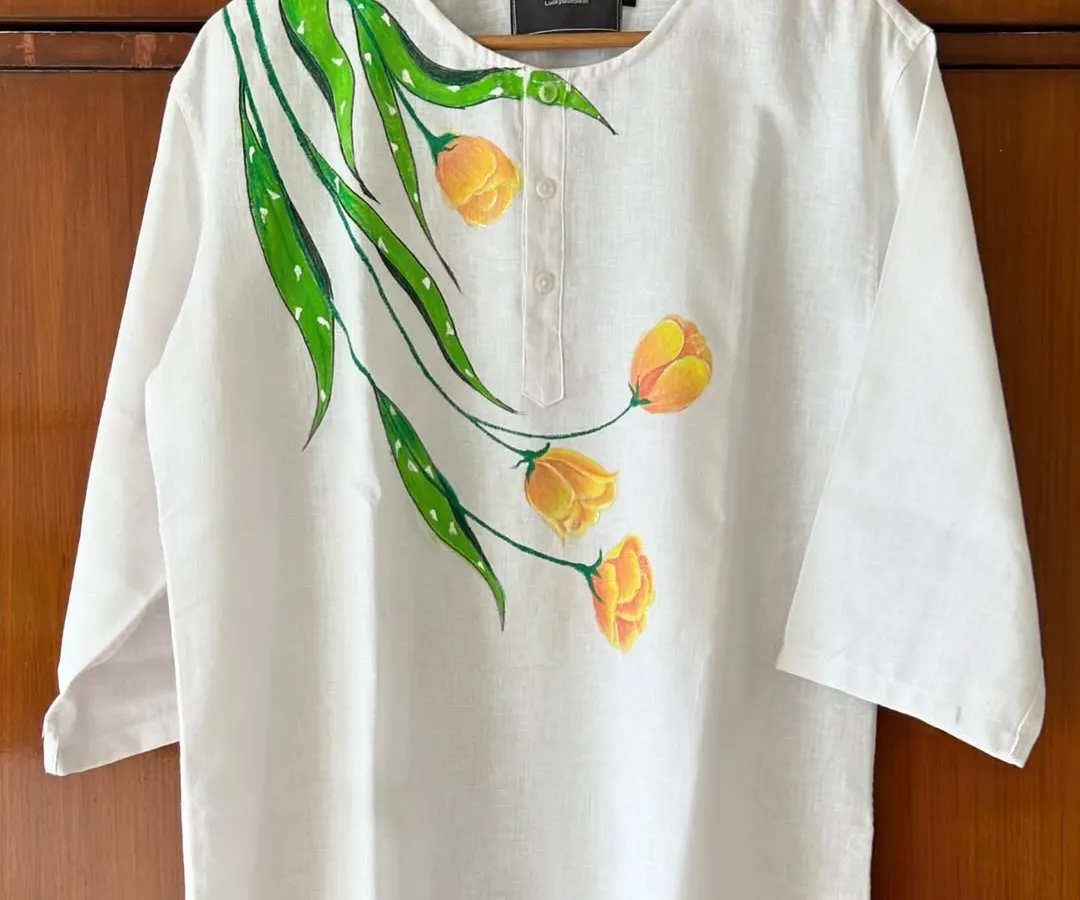 I love turning simple clothing into wearable art. This white linen kurta became a canvas for hand-painted yellow tulips, creating a unique, custom piece of apparel that's perfect for any occasion.