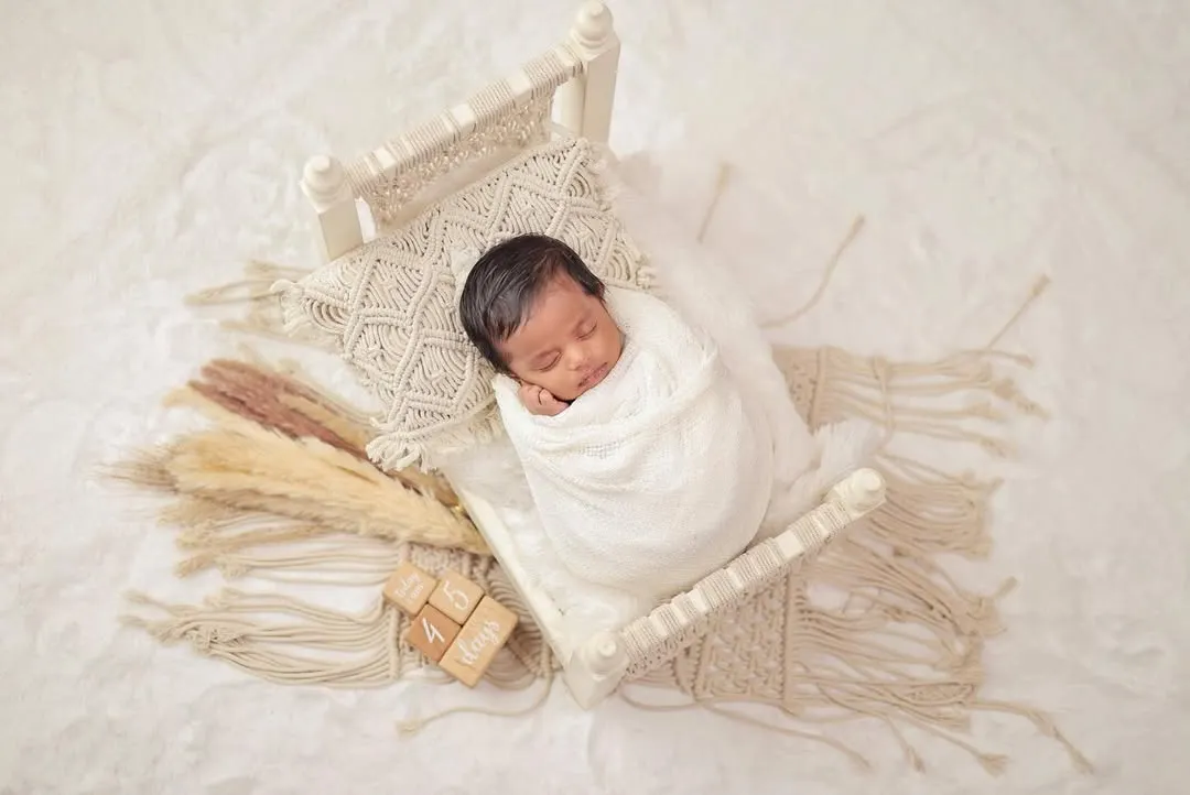 The peaceful, sleepy moments of a newborn are so fleeting. I specialize in creating serene and safe setups, like this cozy macrame bed, to capture your baby's earliest days in a simple, beautiful way.