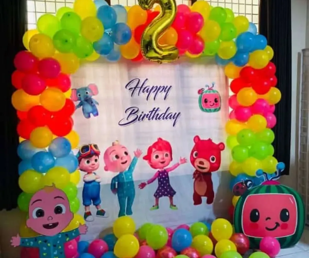 A vibrant and fun Cocomelon theme party for a 2nd birthday. This setup includes a colorful balloon arch, a custom backdrop with all the favorite characters, and a floor full of balloons for the kids to play in.