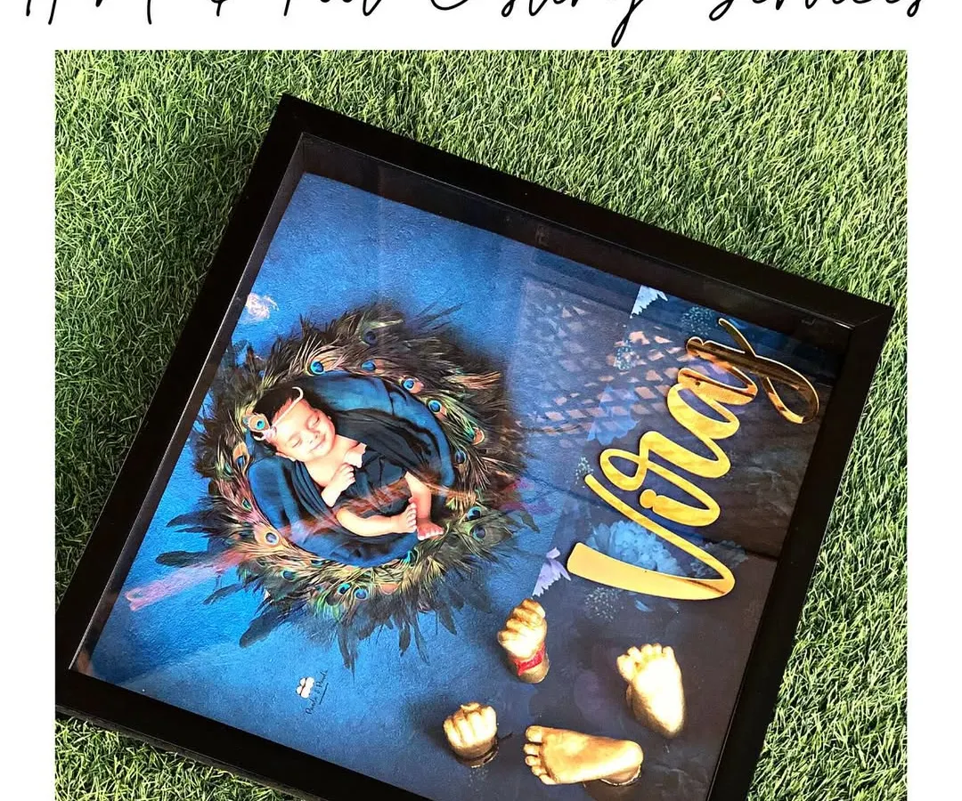 Here is the finished masterpiece, ready to be cherished for a lifetime. This custom shadow box frame includes 3D casts of the baby's hands and feet, a professionally printed photo, and a personalized 3D nameplate. We designed this one with a lovely 'Kanha' theme, using peacock feathers to create a divine look for the little one.