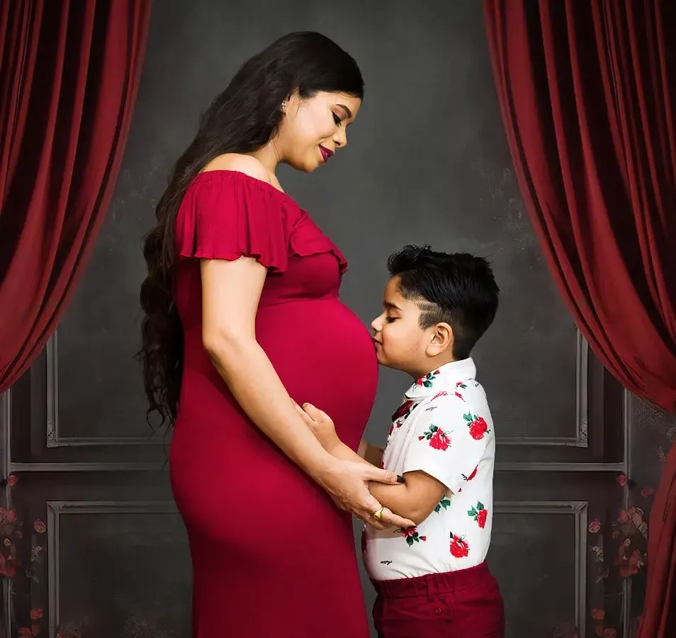 Welcoming a new baby is a family affair. I love capturing moments like this, where an older sibling connects with the baby bump. It’s a beautiful way to document your family's growing love story.