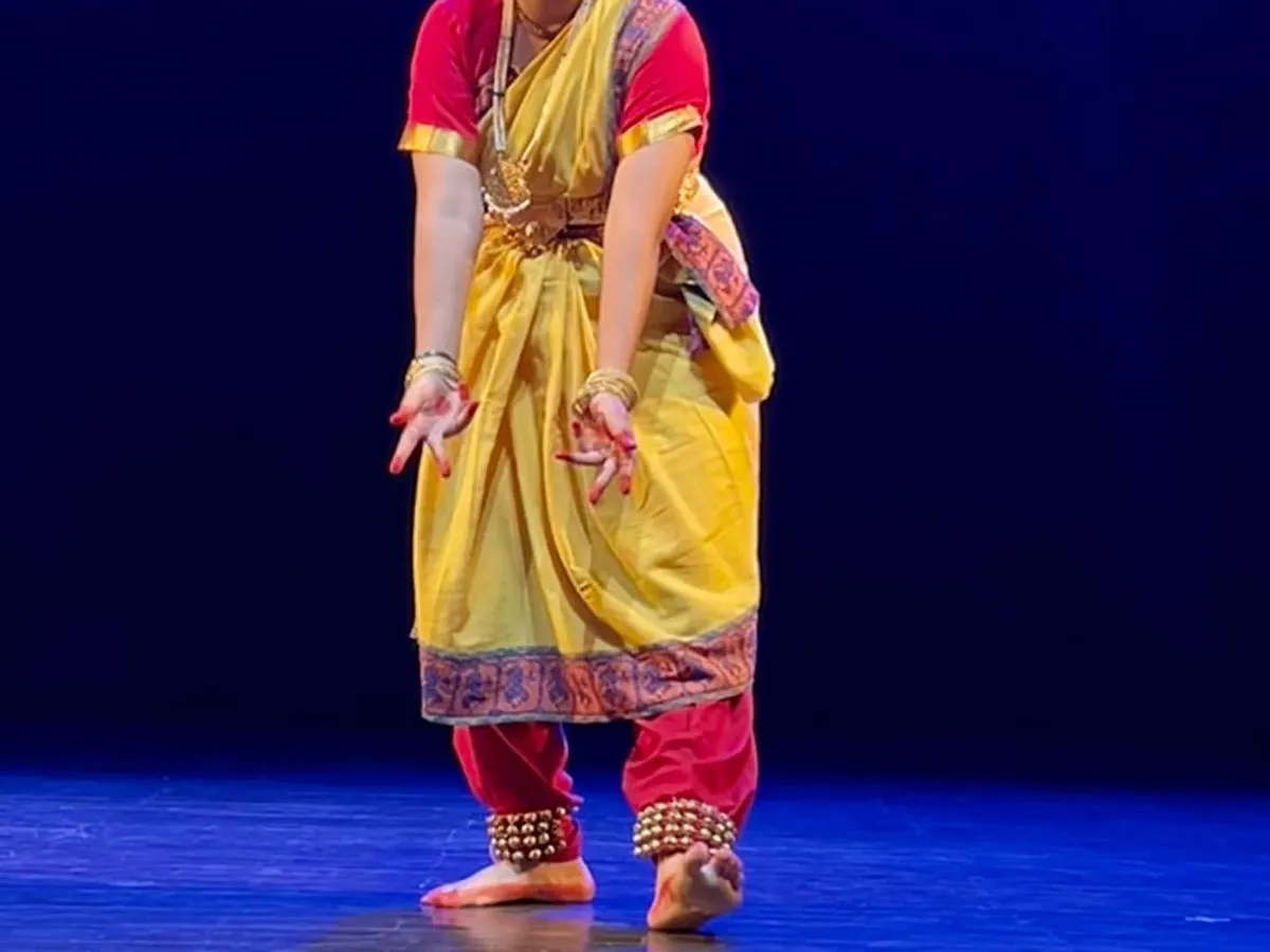 A moment of pure expression from a Bharatnatyam performance. Our classes focus deeply on `abhinaya` (facial expressions) and `mudras` (hand gestures) to tell stories with grace and devotion.