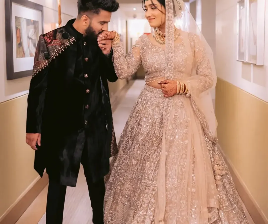 A portrait of togetherness. Here, I have designed a coordinated engagement look where the groom's embellished velvet sherwani perfectly complements the bride's ethereal sequined lehenga, creating a harmonious and regal statement.
