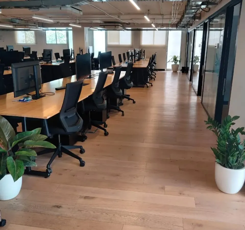 A look at how we integrate greenery into large office spaces. Strategically placed plants in clean, white planters enhance the work environment without disrupting the office flow, improving air quality and aesthetics.