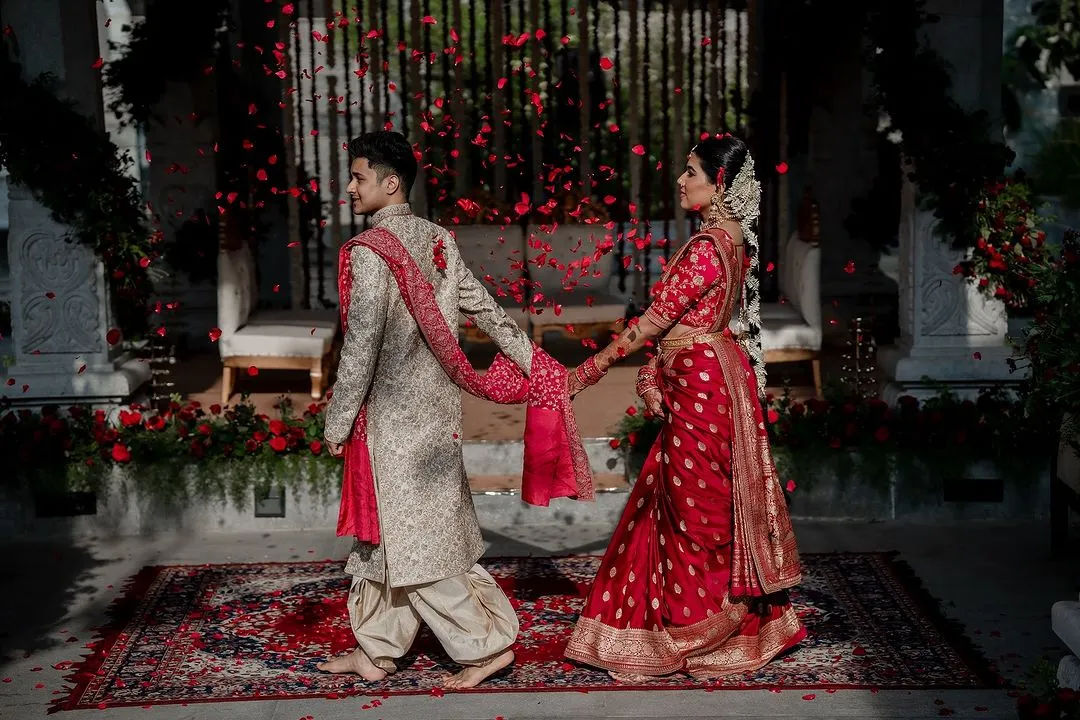 We live for moments like these. A grand exit under a shower of petals for Laksha and Partha, perfectly capturing the magic of their Sabyasachi and Tarun Tahiliani ensembles at the breathtaking Amitarasa venue.