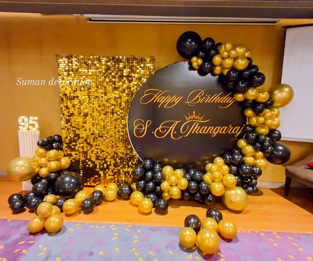 This was a grand 95th birthday celebration. I used a gold sequin shimmer wall for a glamorous photo backdrop, paired with a custom black circular sign. The black and gold balloon garland and light-up marquee number '95' complete this elegant party setup.