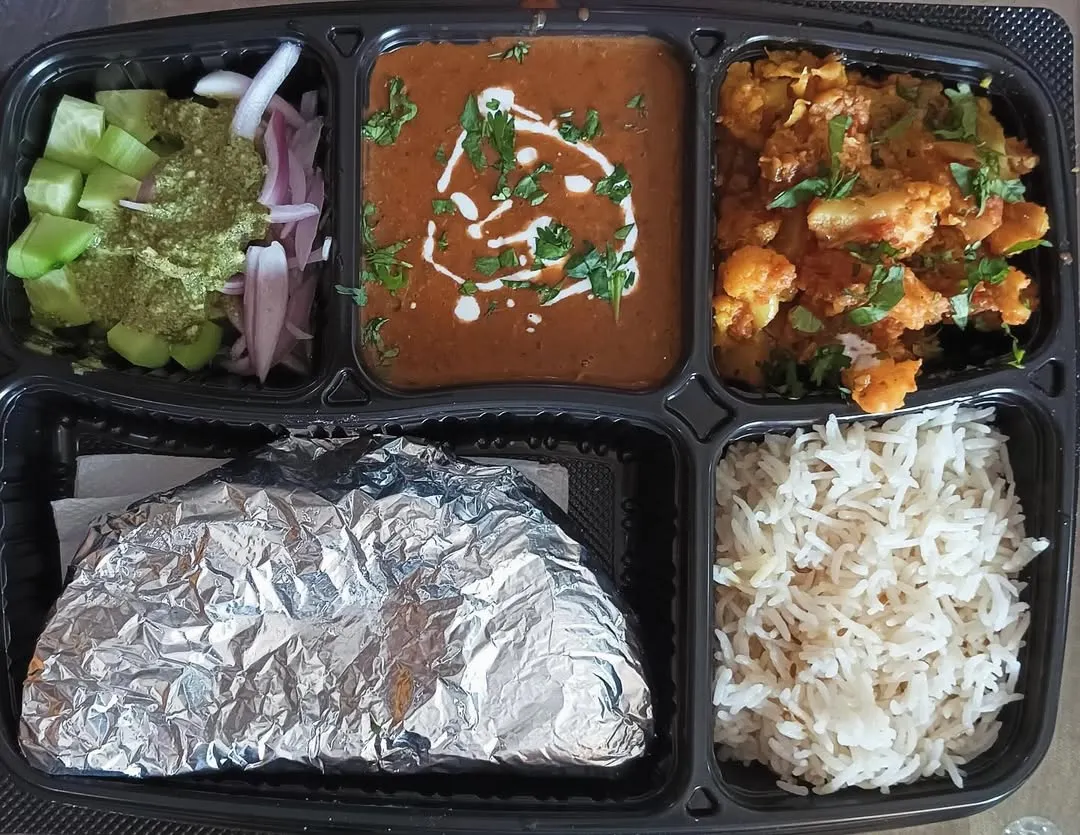 This is a look at one of my classic home-style thalis. It features my special Dal Makhni, a simple Aloo Gobi sabzi, fluffy rice, soft rotis, and a fresh salad. It’s a complete, wholesome meal that will remind you of home.