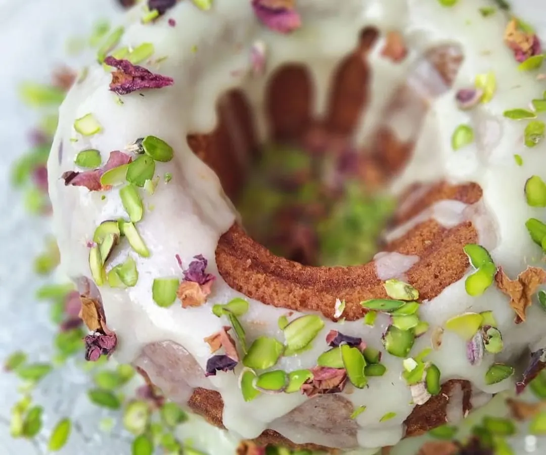My Gulab Jamun Cake is a true showstopper. This is a soft, cardamom-scented bundt cake, soaked in rose syrup and topped with a creamy glaze, pistachios, and dried rose petals. It looks as beautiful as it tastes.